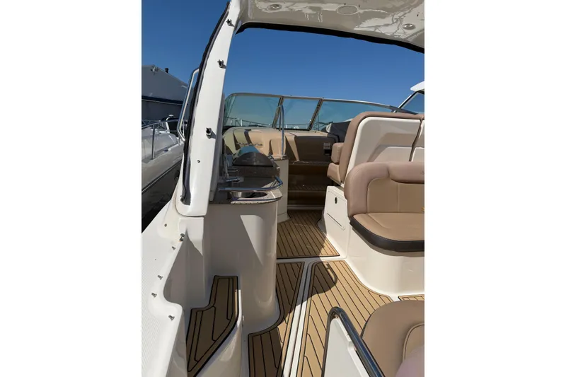 Slide: The Image of 2016 Sea Ray Sundancer 330 interior with tan seating and wood flooring. - 13