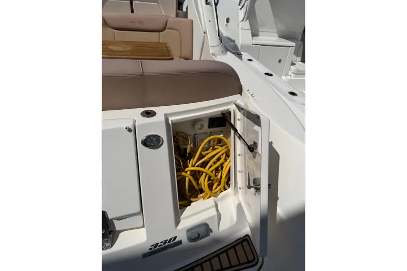 Slide: The Image of 2016 Sea Ray Sundancer 330 boat with open storage compartment and yellow cables. - 28
