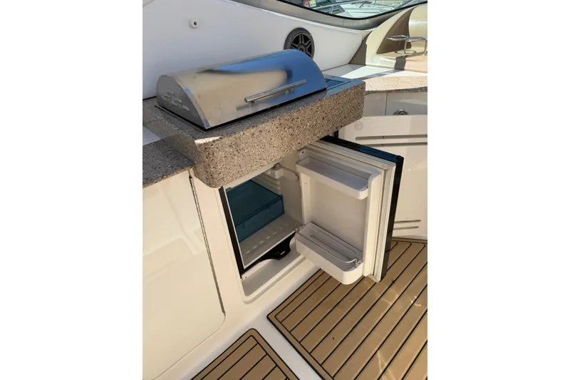 Slide: The Image of Open mini fridge and grill on 2016 Sea Ray Sundancer 330 boat deck. - 14
