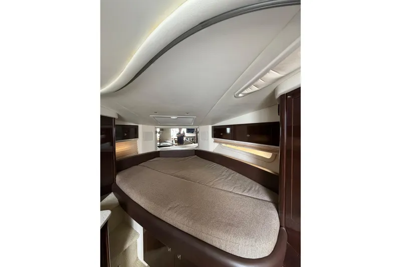 Slide: The Image of Interior cabin of 2016 Sea Ray Sundancer 330 yacht, featuring a cozy bed and modern design. - 30