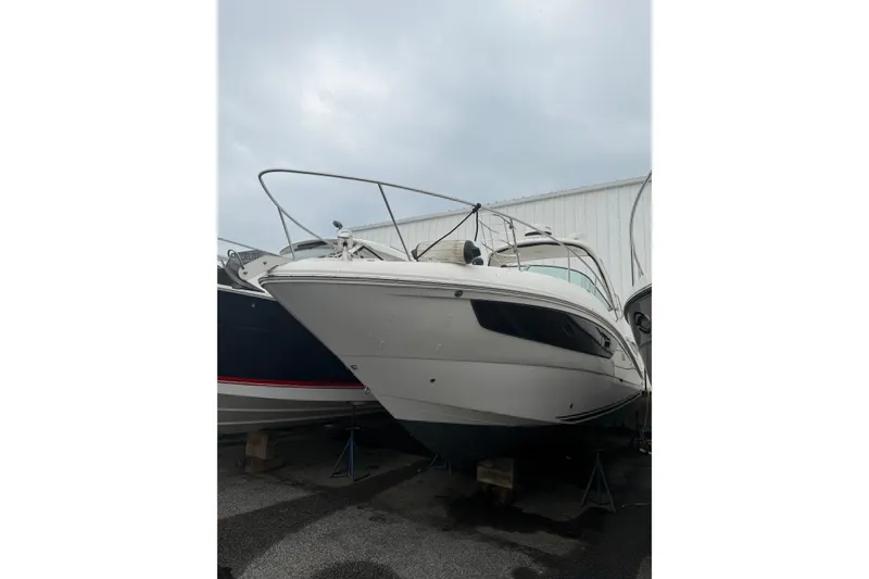 Slide: The Image of 2016 Sea Ray Sundancer 330 boat on stands, displayed outdoors. - 37