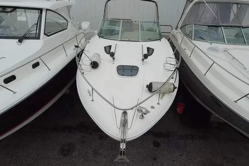 Slide: The Image of 2016 Sea Ray Sundancer 330 yacht docked between two boats. - 4
