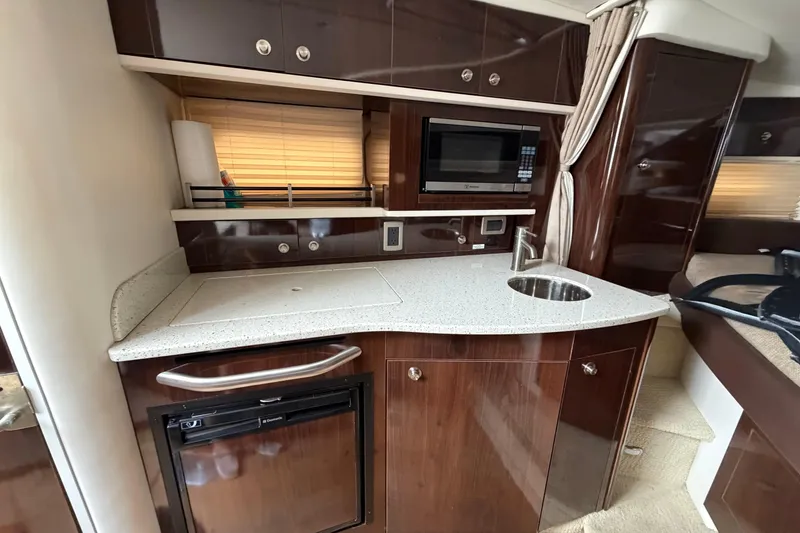 Slide: The Image of Luxurious 2016 Sea Ray Sundancer 330 yacht interior kitchen with modern amenities. - 27