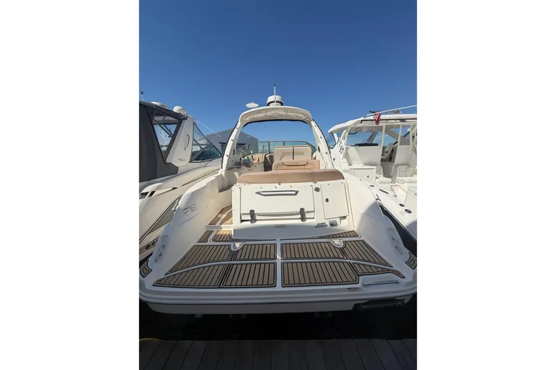 The Image of 2016 Sea Ray Sundancer 330 yacht with spacious deck and sleek design, docked under clear skies. - 1