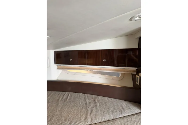 Slide: The Image of Interior cabin of 2016 Sea Ray Sundancer 330 with wood cabinetry and upholstered seating. - 31