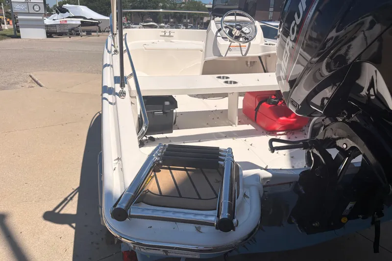 Slide: The Image of 2026 Boston Whaler Super Sport 13 boat with Mercury engine, docked outdoors. - 4