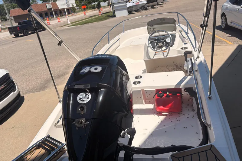 Slide: The Image of 2026 Boston Whaler Super Sport 13 boat with Mercury 40 engine, parked outdoors. - 5