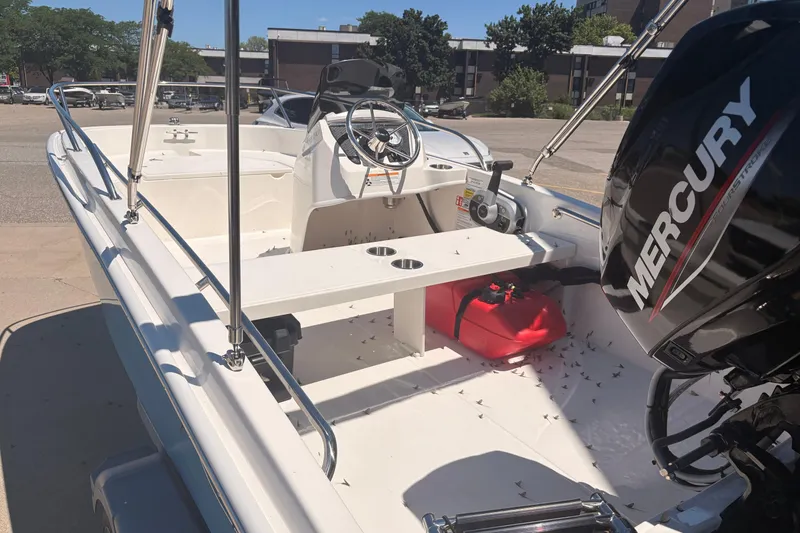 Slide: The Image of 2026 Boston Whaler Super Sport 13 boat with Mercury engine, docked outdoors. - 6