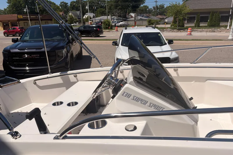 Slide: The Image of 2026 Boston Whaler Super Sport 13 boat interior with steering console and cup holders. - 7