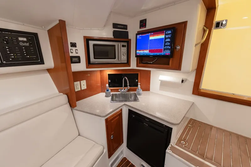 Slide: The Image of Interior of a 2011 Carolina Classic 32 with kitchen and electronics. - 10