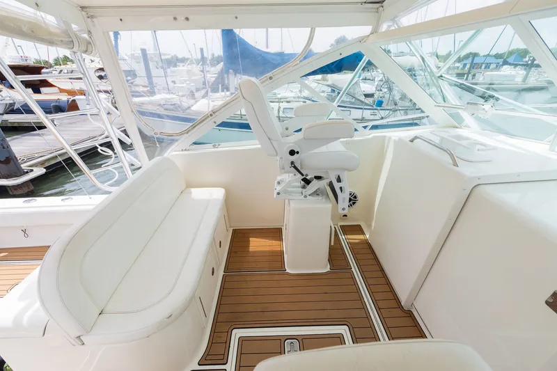 Slide: The Image of The image shows a boat cockpit with white seating and a wooden floor. - 16