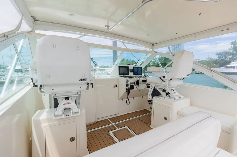 Slide: The Image of The cockpit of a 2011 Carolina Classic 32 with two white captain's chairs and electronic displays. - 18
