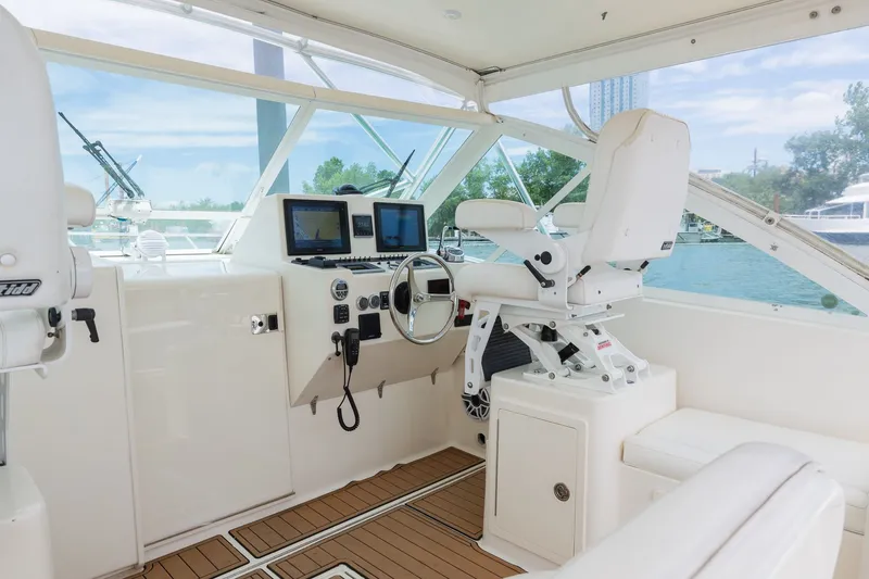 Slide: The Image of The cockpit of a 2011 Carolina Classic 32 with modern navigation systems and comfortable seating. - 19