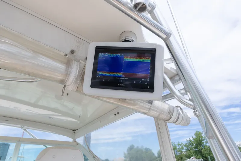 Slide: The Image of A fish finder is mounted on a boat's canopy, with blue sky in the background. - 20