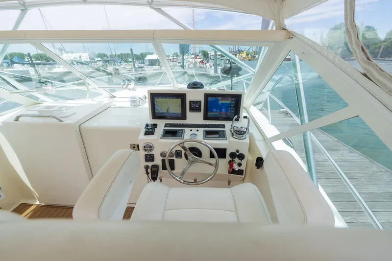 Slide: The Image of The cockpit of a 2011 Carolina Classic 32 with modern navigation systems and sleek white interior. - 21