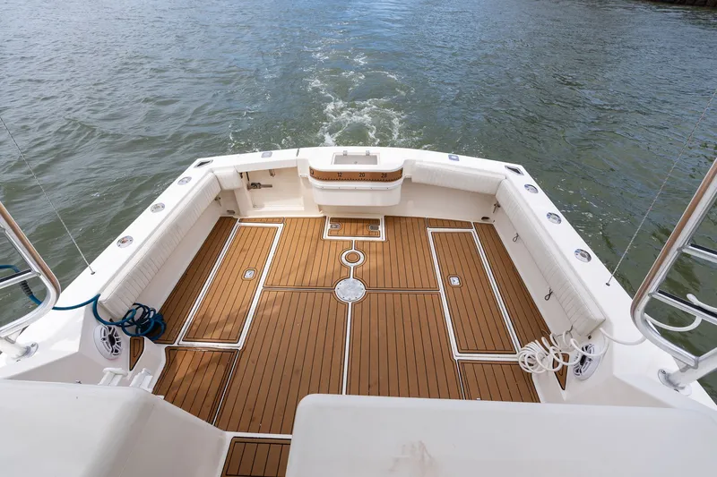Slide: The Image of The image shows a spacious boat's aft deck with wood-look flooring on the water. - 22