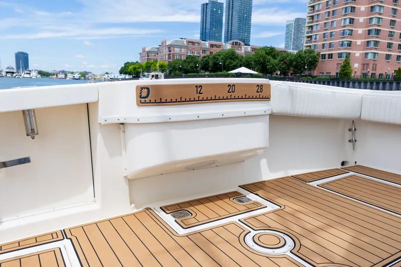 Slide: The Image of The image shows a boat deck with wooden flooring and a measuring board on the wall. - 24