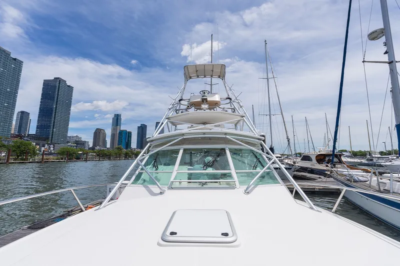 Slide: The Image of A 2011 Carolina Classic 32 boat docked in a marina with skyscrapers in the background. - 27
