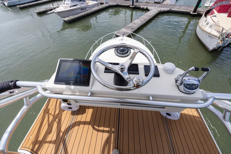 Slide: The Image of Boat helm with steering wheel and electronics, docked in a marina. - 30
