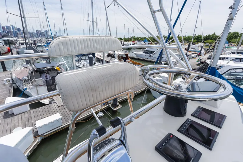 Slide: The Image of The helm of a 2011 Carolina Classic 32 in a marina. - 32