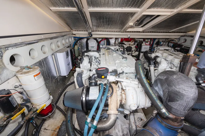 Slide: The Image of Engine room of a 2011 Carolina Classic 32 with two large engines and technical components. - 39