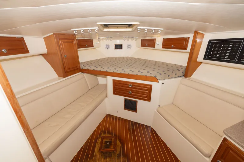 Slide: The Image of Interior of a 2011 Carolina Classic 32 with wood flooring and cushioned seating. - 4