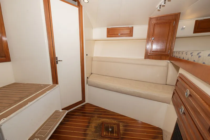 Slide: The Image of Interior of a 2011 Carolina Classic 32 with wooden flooring and seating area. - 6