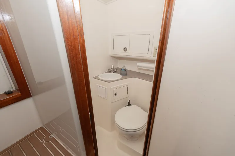 Slide: The Image of The image shows a clean boat bathroom with a sink and toilet. - 9