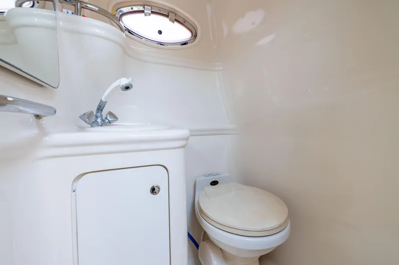 Slide: The Image of 2002 Searay 260 Sundancer boat bathroom with sink and toilet. - 10
