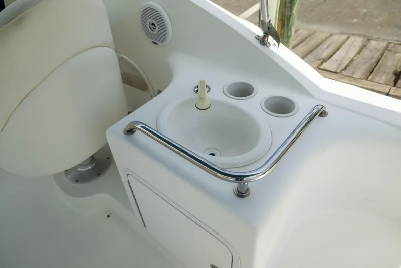 Slide: The Image of Interior view of a 2002 Searay 260 Sundancer boat featuring a compact sink area. - 25
