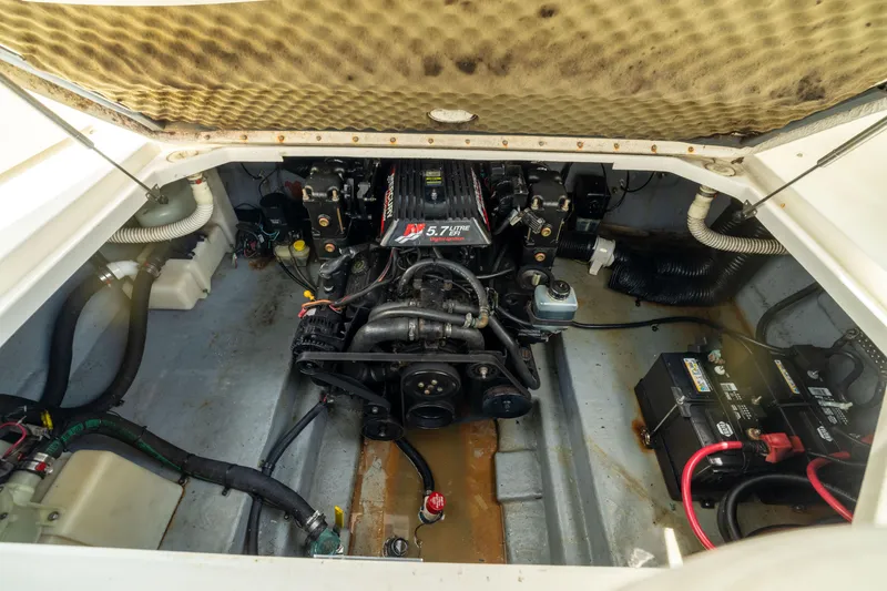 Slide: The Image of Engine compartment of a 2002 Searay 260 Sundancer boat, featuring a 5.7L engine. - 28