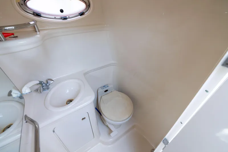 Slide: The Image of 2002 Searay 260 Sundancer boat bathroom with sink and toilet. - 9