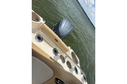 Slide: The Image of 2014 Scout 240 Bay Scout boat on water, featuring sleek design and powerful engine. - 2