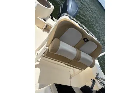 Slide: The Image of 2014 Scout 240 Bay Scout boat interior with cushioned seating and water view. - 3