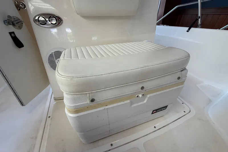 Slide: The Image of 2004 Boston Whaler 220 Dauntless boat seat with integrated storage and speaker. - 11