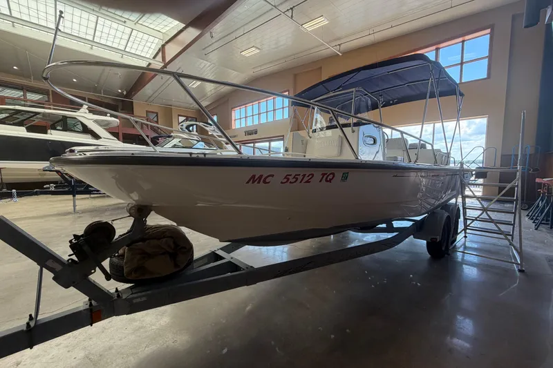 Slide: The Image of 2004 Boston Whaler 220 Dauntless boat on trailer in indoor storage facility. - 2