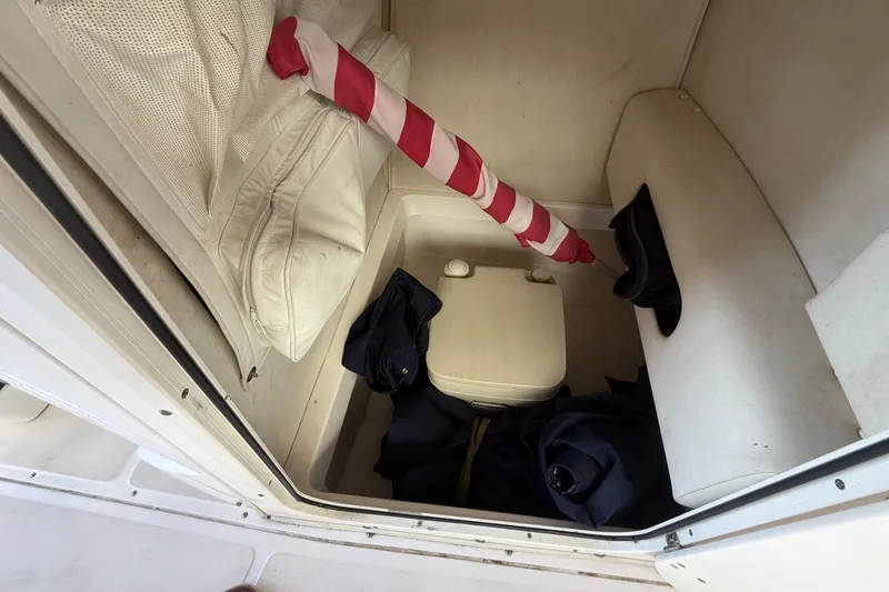 Slide: The Image of Storage compartment of a 2004 Boston Whaler 220 Dauntless boat with cushions and gear. - 9