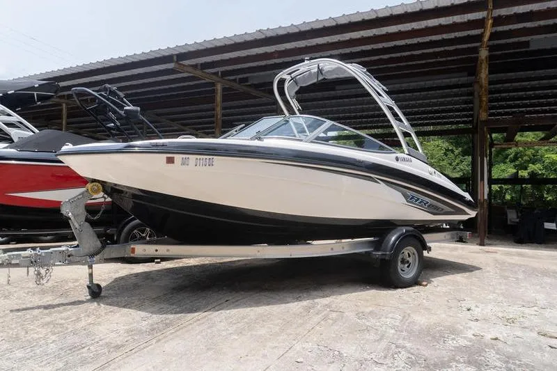 Slide: The Image of 2017 Yamaha Boats AR190 on trailer under a covered area. - 21