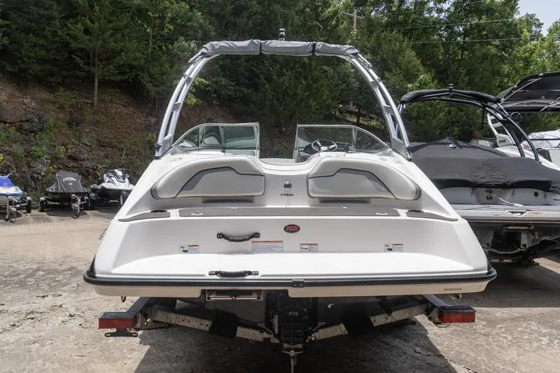 Slide: The Image of 2017 Yamaha Boats AR190, rear view, parked outdoors with trees in background. - 24