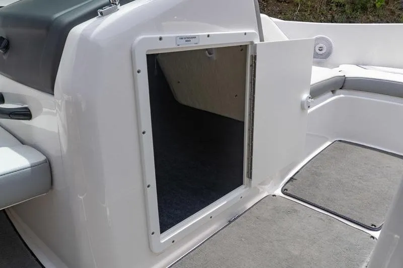 Slide: The Image of 2017 Yamaha Boats AR190 storage compartment with open hatch, showcasing interior space and seating area. - 28