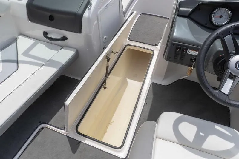 Slide: The Image of 2017 Yamaha Boats AR190 interior storage compartment and steering wheel. - 29