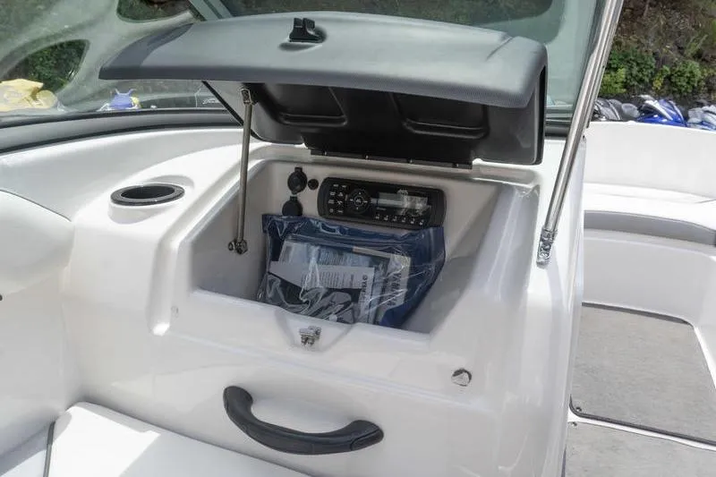 Slide: The Image of 2017 Yamaha Boats AR190 glove compartment with stereo system and storage space. - 34