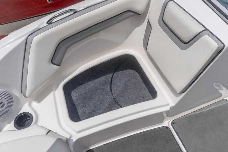 Slide: The Image of 2017 Yamaha AR190 boat interior seating with storage compartment and cup holder. - 39
