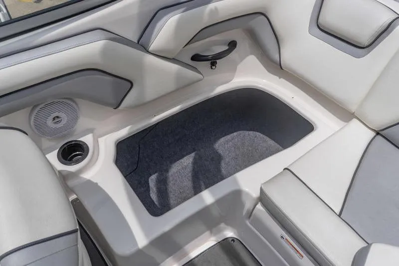 Slide: The Image of 2017 Yamaha Boats AR190 interior seating area with storage compartment and speaker. - 42