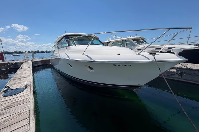 The Image of 2016 Tiara Yachts C39 Coupe docked at marina under clear blue sky. - 0