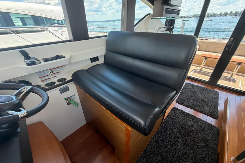 Slide: The Image of Interior of 2016 Tiara Yachts C39 Coupe with black leather seating and steering wheel. - 19