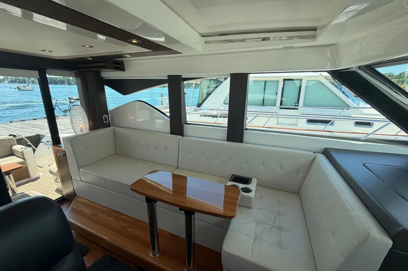 Slide: The Image of Interior of 2016 Tiara Yachts C39 Coupe with white seating and wooden table. - 20