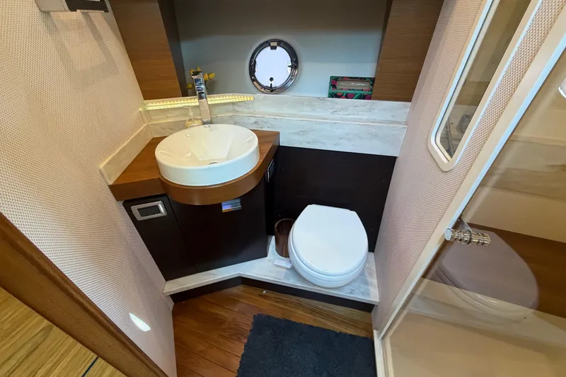 Slide: The Image of Bathroom interior of 2016 Tiara Yachts C39 Coupe with sink, toilet, and porthole. - 22