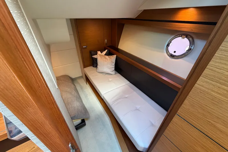 Slide: The Image of 2016 Tiara Yachts C39 Coupe interior cabin with modern wood finish and cozy seating. - 25