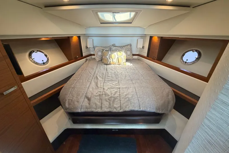 Slide: The Image of Luxurious cabin interior of 2016 Tiara Yachts C39 Coupe with cozy bed and porthole windows. - 26